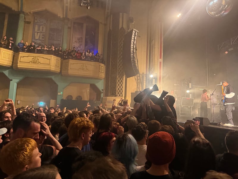 A steady stream of crowdsurfers made their way to the crash barrier throughout the gig.