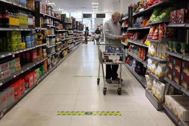 A man shops at a Waitrose supermarket in London. The supermarket has launched its new Little Treats rewards nationwide for My Waitrose members (Photo: HOLLIE ADAMS/AFP via Getty Images)