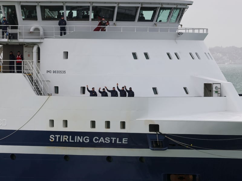 Ships company waving to well wishers on round tower as HMS Stirling Castle proceeds in to Portsmouth Harbour.