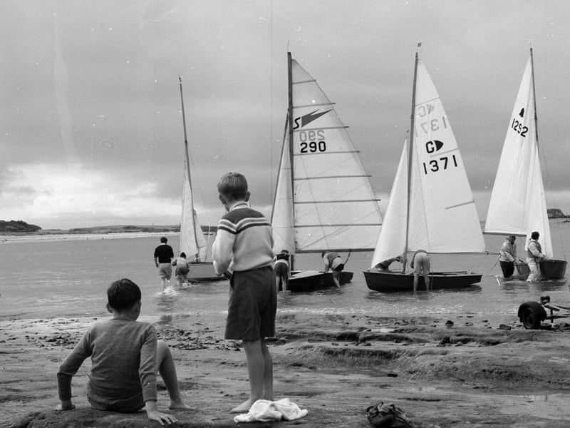 Children watch yachts sail from North Berwick Harbour in July 1962.