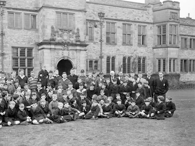 English rugby players pose with local pupils outside Carlekemp Priory School in March 1960.