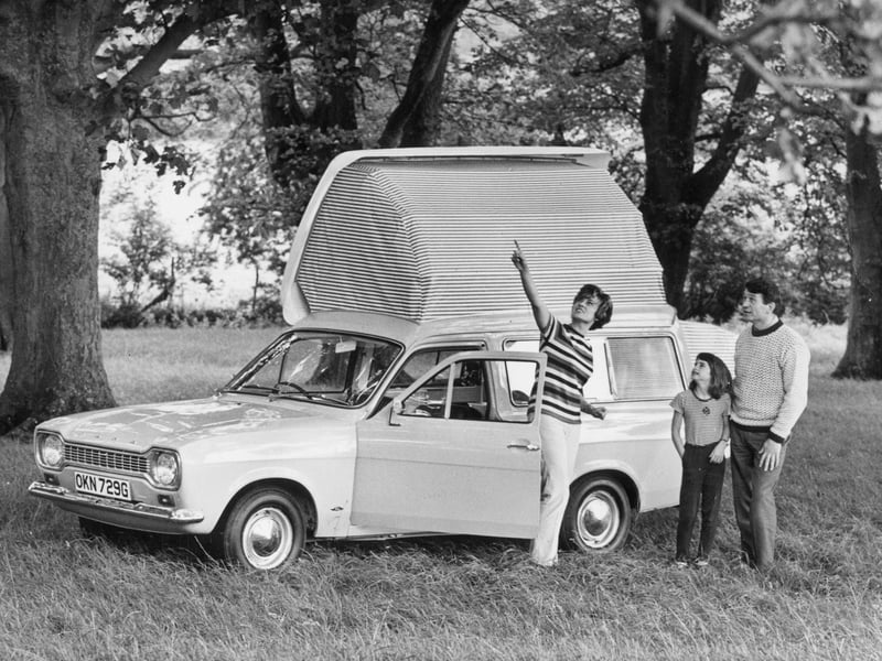 A family beside a 1968 Ford Escort Dormobile Elba