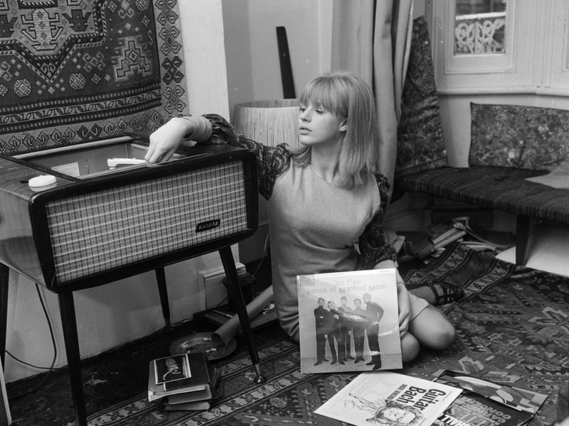 Marianne Faithfull playing records at her home in Reading in October 1964, including albums by Pete Seeger and Manfred Mann