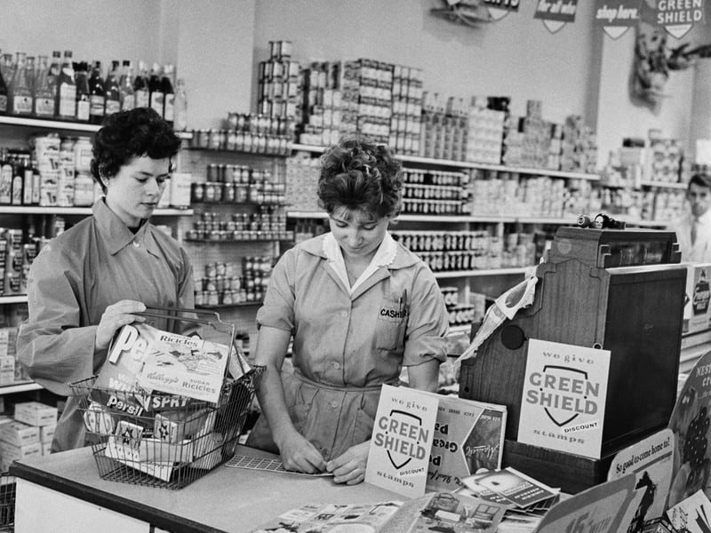 A shop assistant prepares to hand a sheet of Green Shield stamps to a customer at a newly opened supermarket in September 1960. The stamps could be used to buy gifts from a catalogue or from any affiliated retailer.