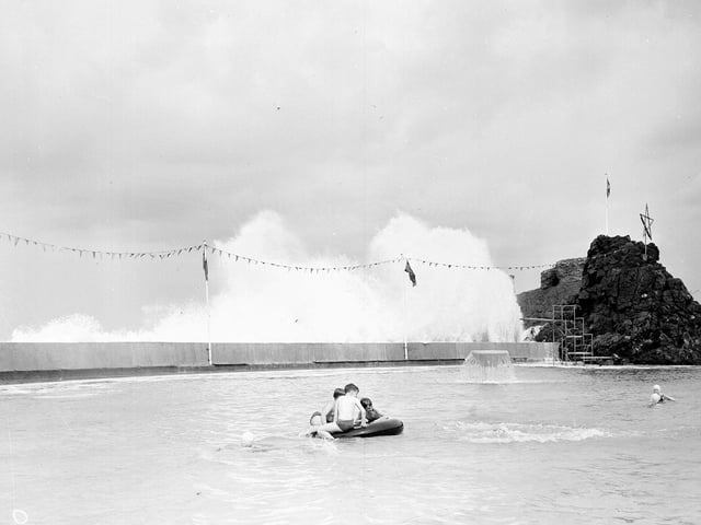 Waves crashing over Dunbar Swimming Pool in July 1963.