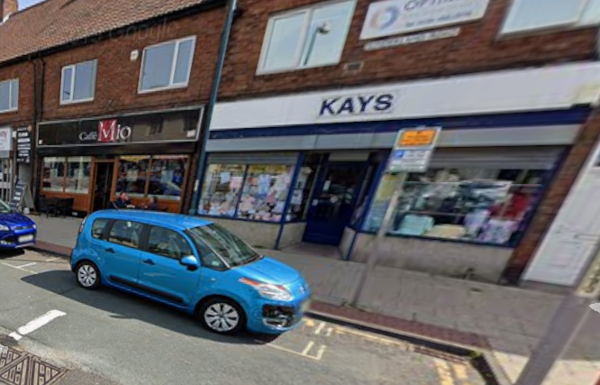 Cafe Mio and Kays childrens clothes shop in a view from May 2018.