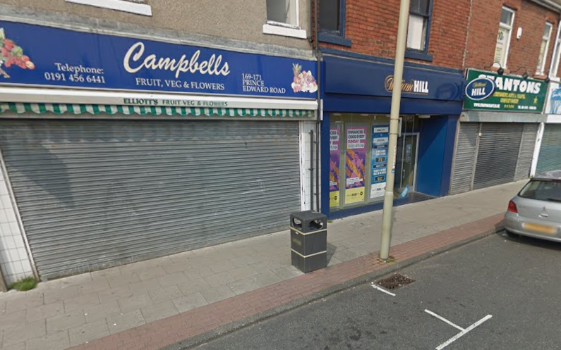 Campbells for fruit, veg and flowers with William Hill next door and Stantons stationery shop further up the street in May 2016.