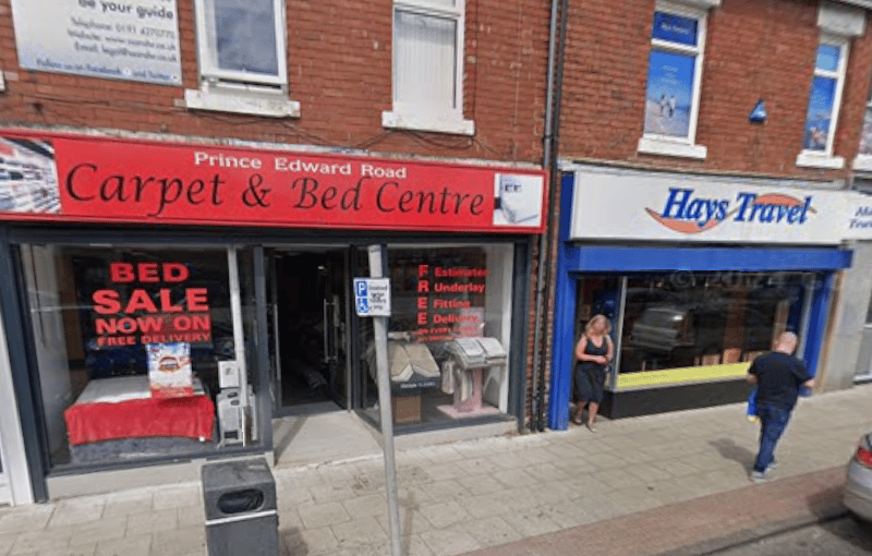 Taking you back to June 2022 for a view of the Prince Edward Road Carpet & Bed Centre, with a branch of Hays Travel next door.