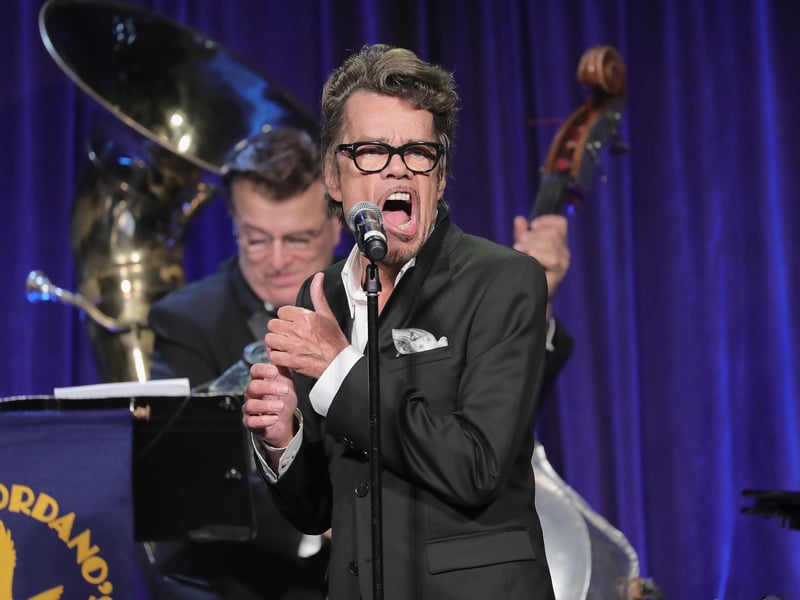 This 1980s transformation was a massive commercial success that completely overshadowed the artist's punk rock roots. The flamboyant, tuxedo-clad lounge singer Buster Poindexter is, in fact, David Johansen, the gritty lead singer of the pioneering punk band The New York Dolls. As Poindexter, he had his biggest hit, the inescapable single 'Hot Hot Hot.'