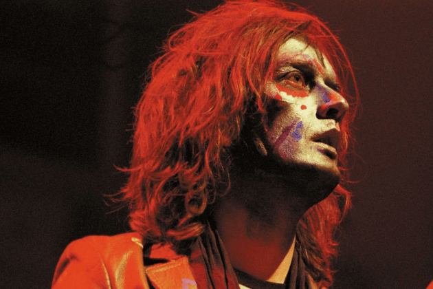 Saving the grittiest shift for last is Darren Spooner, the skeletal, abrasive, karate-loving frontman of the electro-rock band Relaxed Muscle. This unsettling persona was completely inhabited by Jarvis Cocker, the famously literate and dandy-like singer of Pulp. Cocker created the alter-ego to explore a darker, more primitive side of performance, giving him an aggressive outlet that contrasted sharply with his witty, observational songwriting.