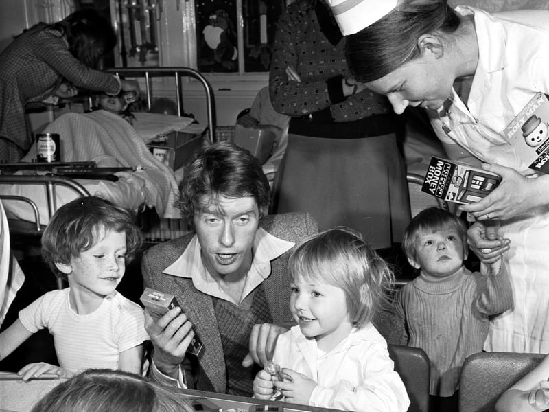 Actor and singer Michael Crawford hands out the gifts donated to the Evening News/Odeon Christmas Appeal at the Sick Children's Hospital, Edinburgh, in December 1973