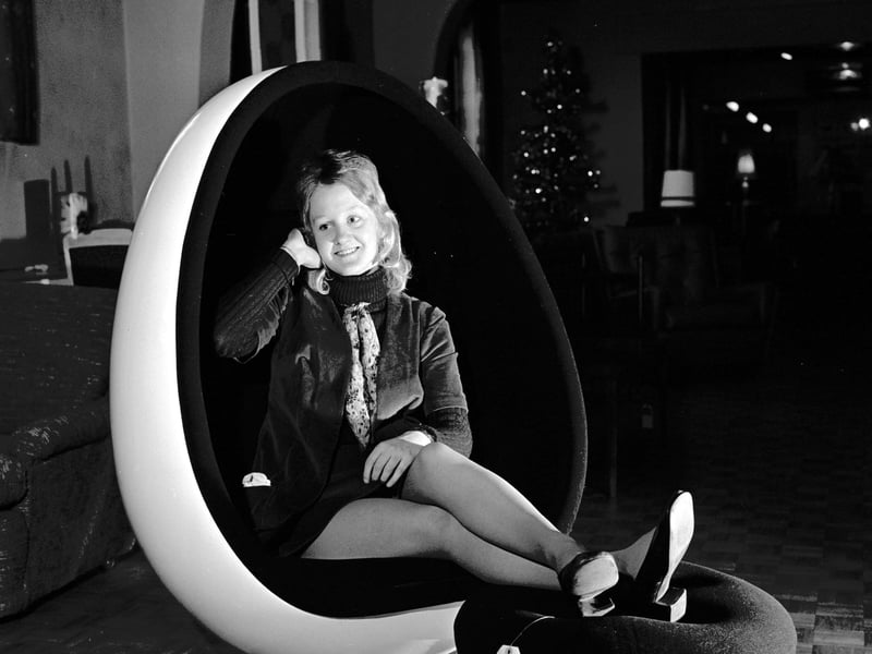 A girl tries out a chair with inbuilt stereo speakers at Jenners department store, Edinburgh, in December 1971.