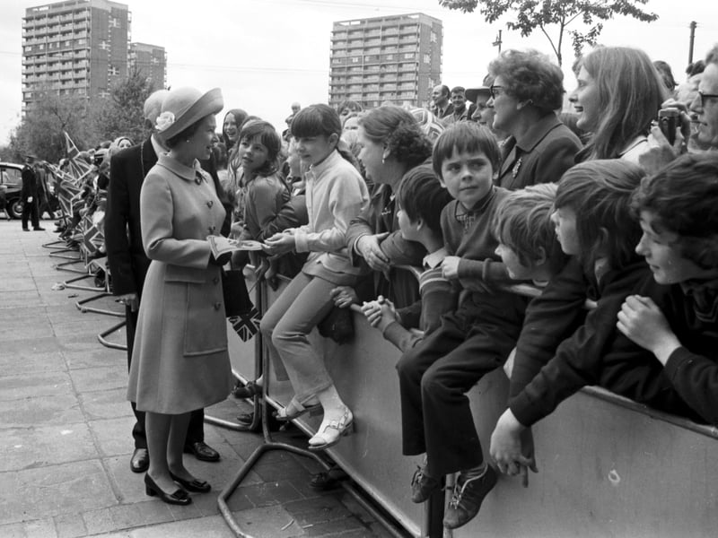 Queen Elizabeth II meets children outside the new multi-storey flats at the Gorbals, Glasgow, in July 1972