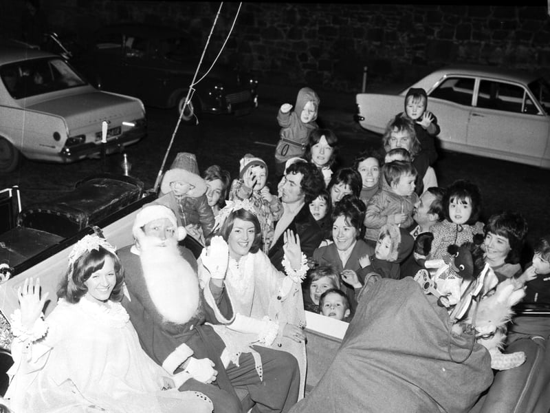 Children greet Santa as he and his helpers arrive by sleigh at Patrick Thomson's department store in North Bridge, Edinburgh, in November 1973