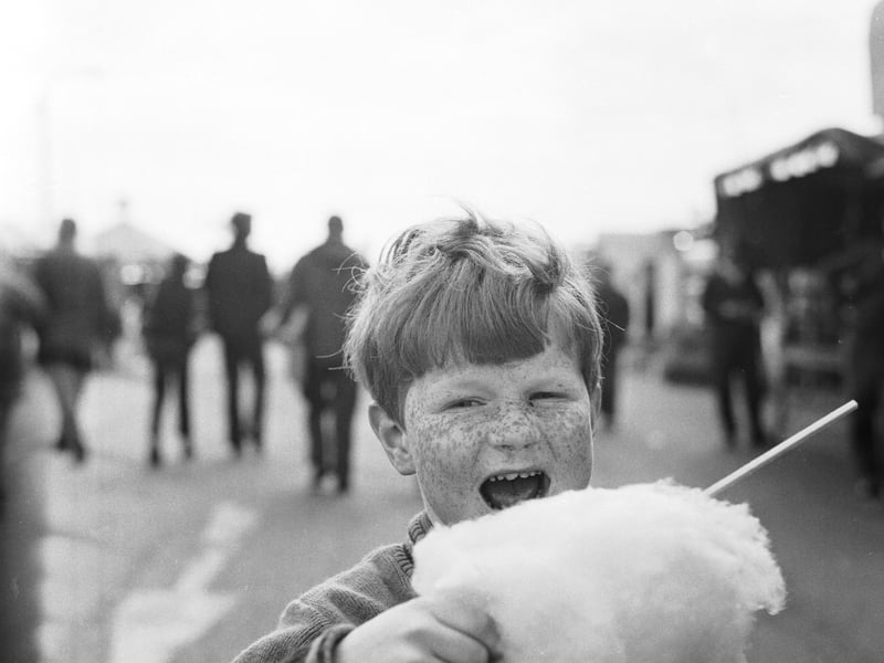 A boy bites into some candyfloss at the Links Market,  Kirkcaldy, in April 1973
