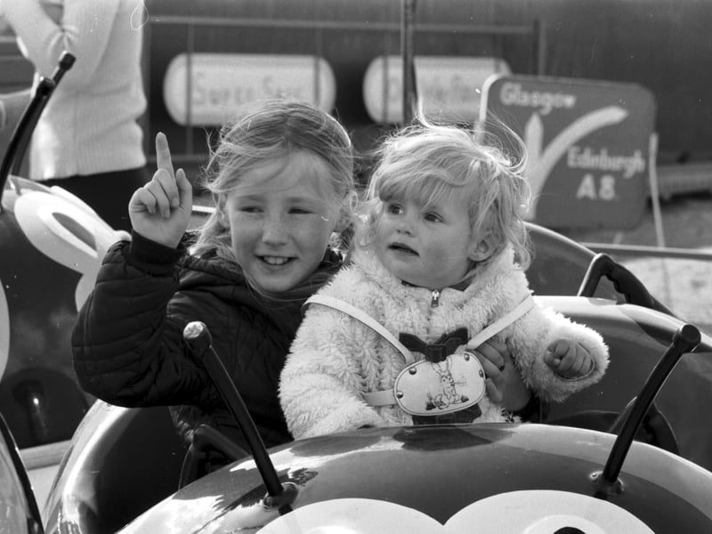 Two girls on the merry-go-round at the Links Market, Kirkcaldy, in April 1973