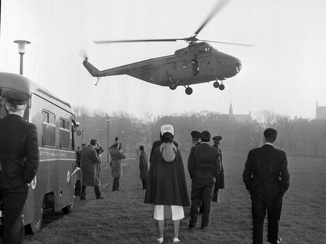 A helicopter carrying a young girl suffering severe burns landing in the Meadows in January 1964.