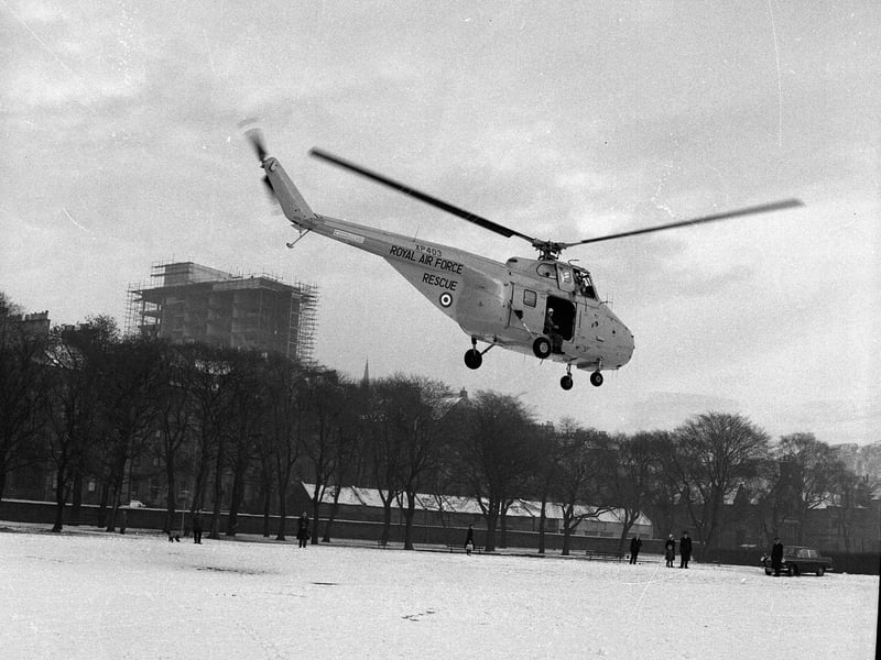 A RAF Helicopter lands in the Meadows to make a food drop to 14 people stranded by snow on Byreclough Farm in January 1963.