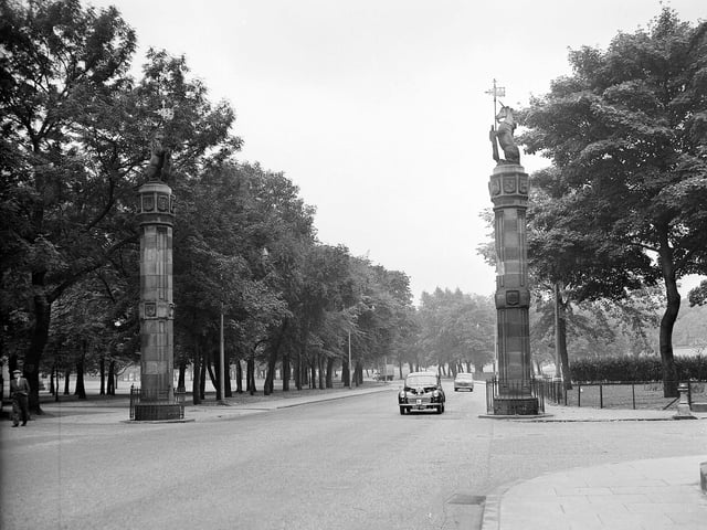 The monumental red stone pillars displaying the many kinds of stone used in Edinburgh buildings in August 1962. These were erected in 1886 on each side of Melville Drive at the western end.