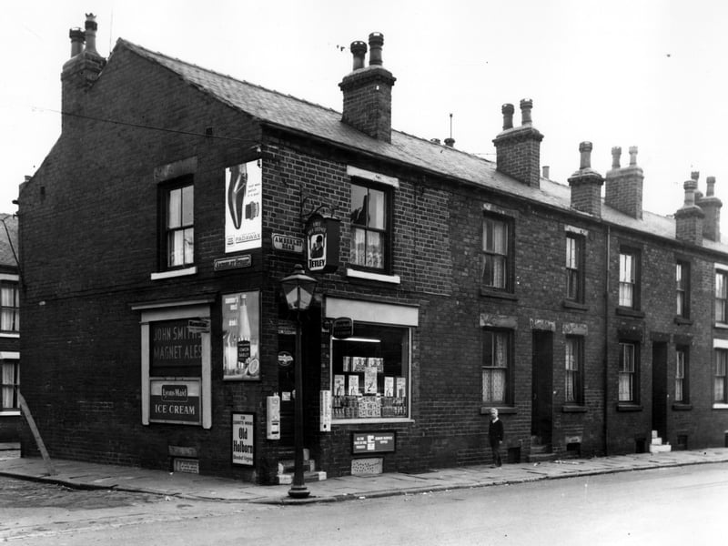 Amberley Street is on the left with Oldfield Street just in view. Number 42 Amberley Road is a grocers and off licence shop. One of the window powder at 2/- (10p) a packet. Also offered is a free picture.