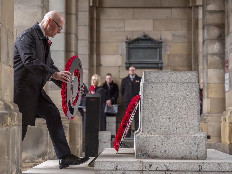 First Minister John Swinney lays a wreath at the Stone of Remembrance outside the City Chambers in Edinburgh.