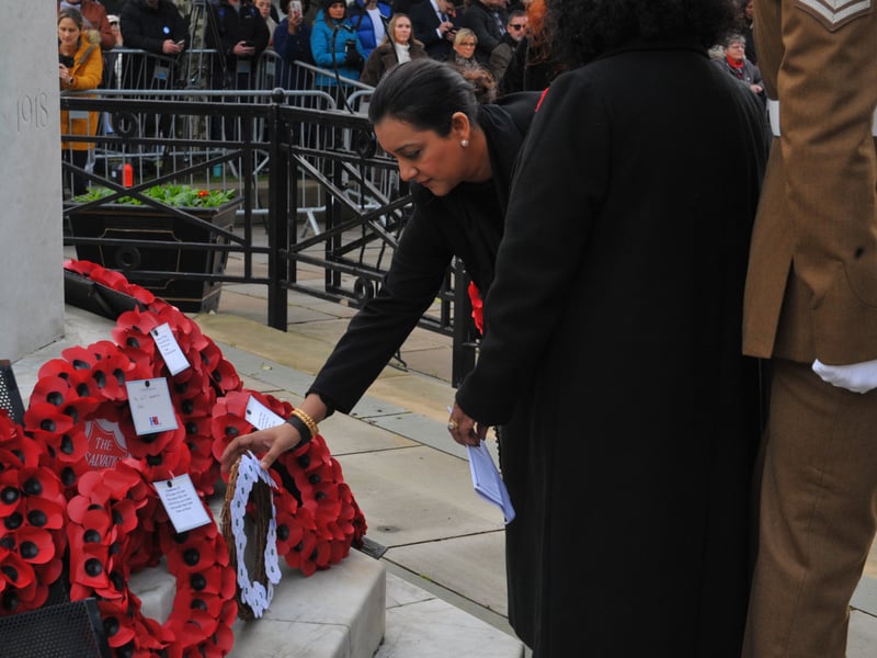 Coun Salma Arif, Gipton and Harehills Labour, lays a wreath of white poppies.