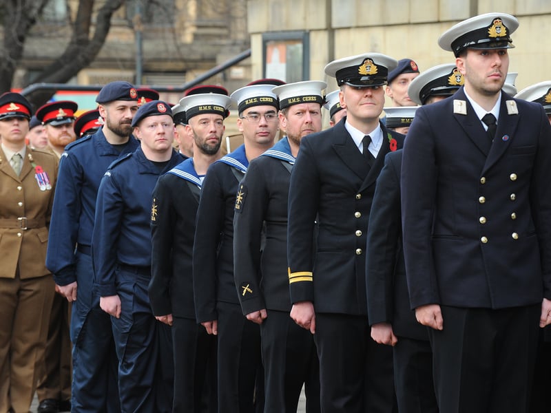 Military personnel from across the different branches of the armed forces line up along Victoria Gardens.