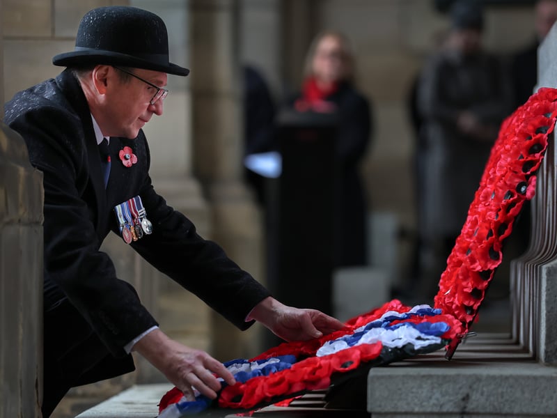 A dignitary lays down a wreath during Remembrance Sunday tributes.