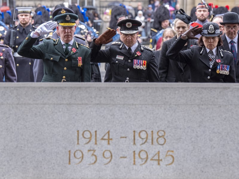 Chief Executive of the Scottish Ambulance Service Michael Dickson, Chief Officer of Scottish Fire and Rescue Stuart Stevens and Chief Constable of Police Scotland Jo Farrell at the Stone of Remembrance outside the City Chambers in Edinburgh.
