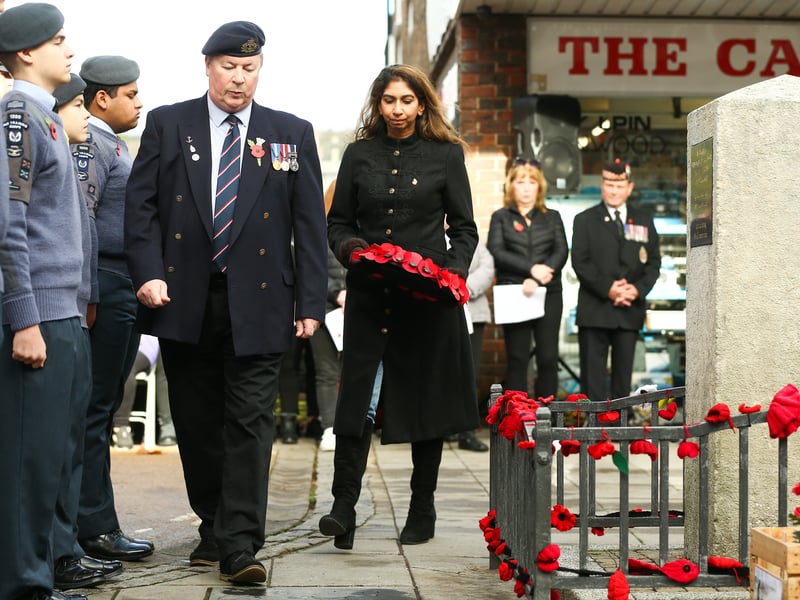 Suella Braverman carrying a wreath at the Portchester Remembrance service.