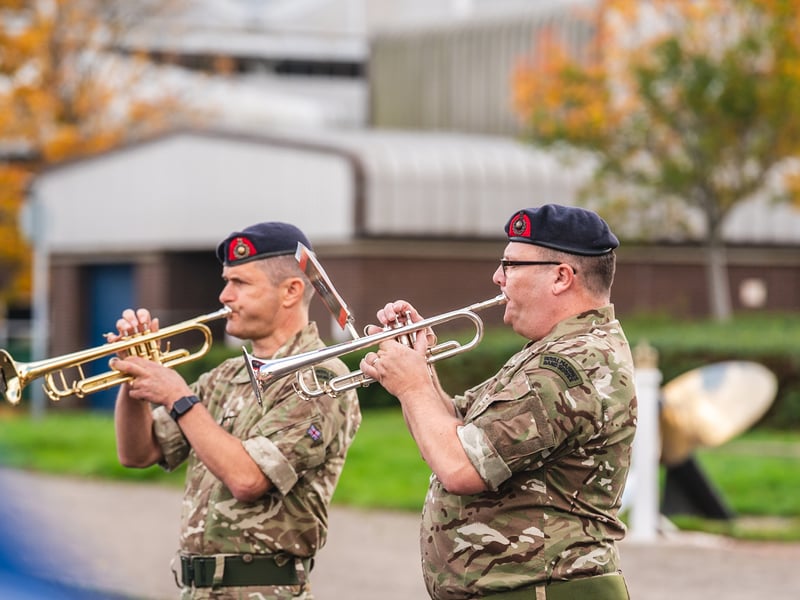 Personnel play the last post at HMS Sultan.
