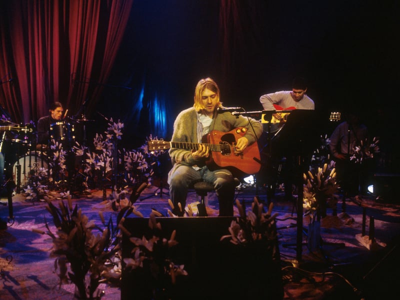 Kurt Cobain requested the stage be decorated with stargazer lilies, black candles, and a crystal chandelier. This dark, deliberate aesthetic starkly contrasted the usual bright, daytime atmosphere of the MTV Unplugged series.