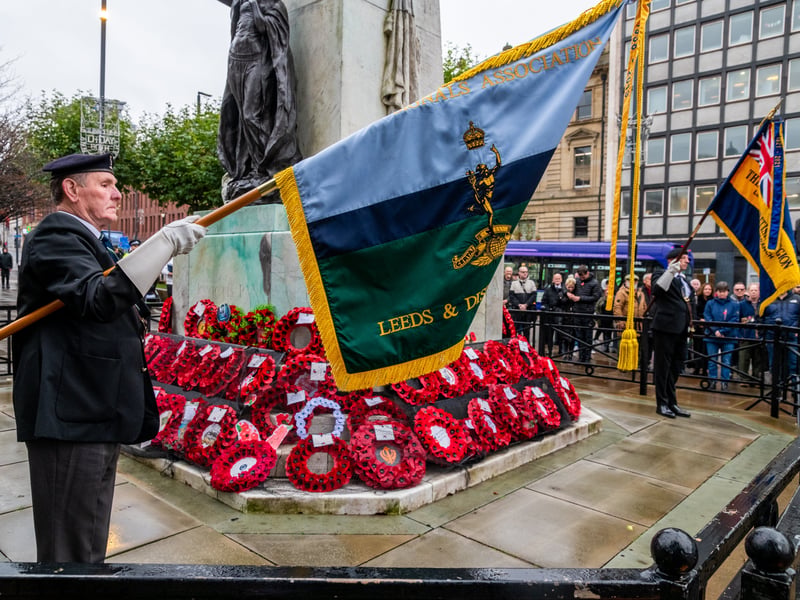 Standard-bearers lowering their standards in mark of respect to those who have fallen during the sounding of the Last Post.