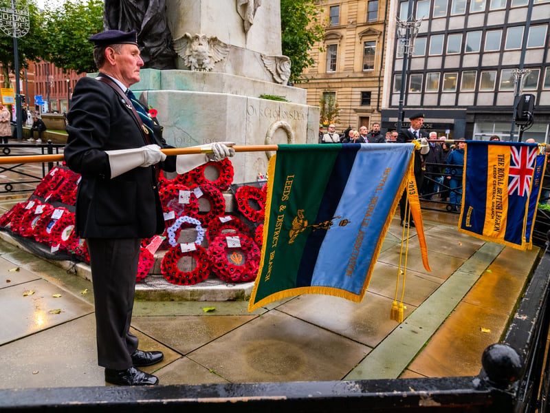 Standard-bearers lowering their standards in mark of respect to those who have fallen during the sounding of the Last Post.
