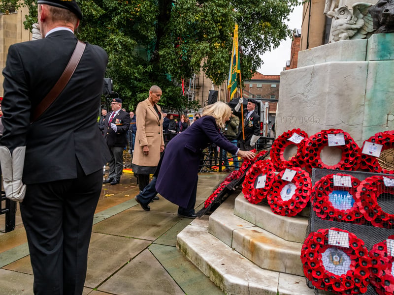 Tracy Brabin, Mayor of West Yorkshire, laying a wreath at the Leeds Cenotaph, watched by Alison Lowe,  Deputy Mayor for West Yorkshire for Policing and Crime in West Yorkshire.
