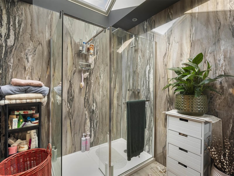 The well-presented en-suite shower room for the East Lothian property's principal bedroom.