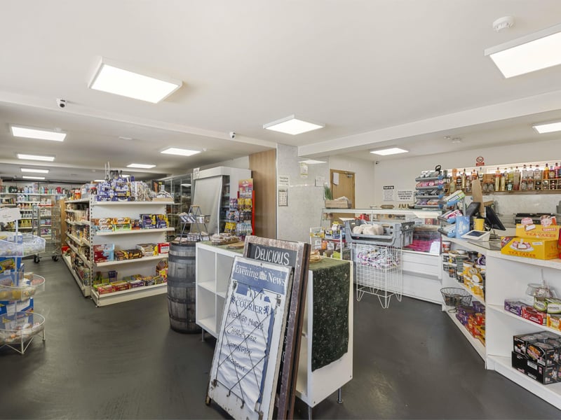 The shop space, which is currently trading but will close upon completion of sale. This substantial area provides scope for a range of alternative uses, subject to any necessary consents.