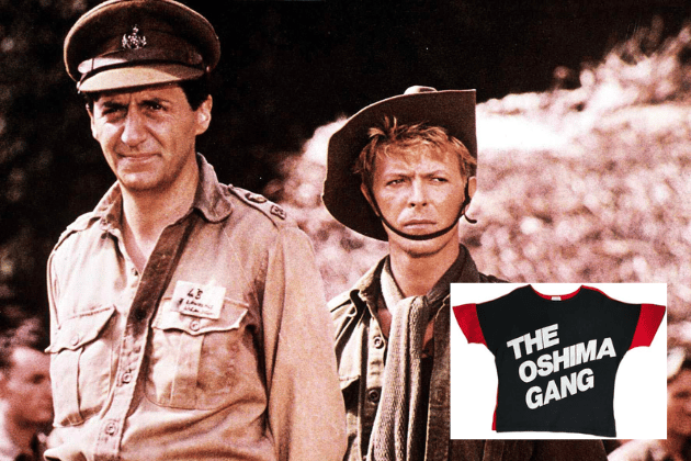 This is an incredibly rare, original vintage UK T-shirt tied directly to David Bowie's film career. Produced exclusively for the crew working on the 1983 movie, Merry Christmas Mr. Lawrence, this 100% cotton tee is a genuine piece of cinematic memorabilia. The front features the white text 'The Oshima Gang'—a tribute to director Nagisa Oshima—on a black background. The red reverse displays the film's title. This shirt is an extremely hard-to-find and highly collectable relic, offering a unique, behind-the-scenes connection to Bowie's work on screen.