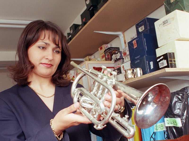 Manager Sam Swann pictured with a pawned instrument, at Herbert Brown Pawnbrokers, Pinstone Street, Sheffield, in June 1999
