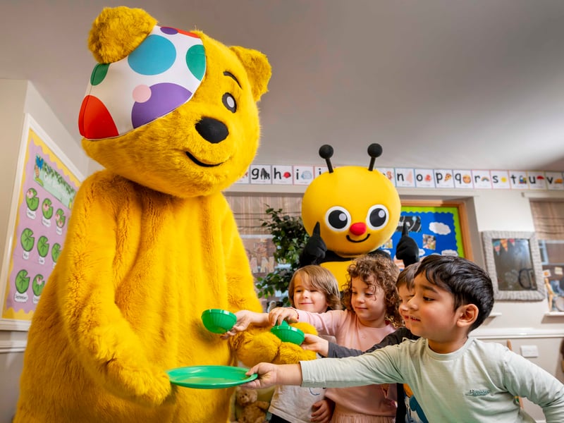 The children offer Pudsey a cup of tea.