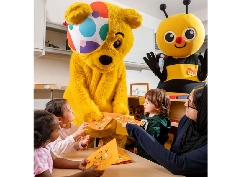 Children give Pudsey their kindness cards.