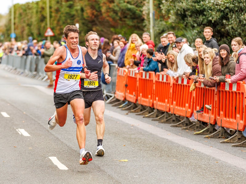 Two runners race to the finish line