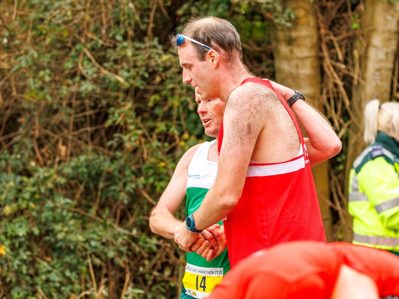 Two runners congratulate each other at the finish line