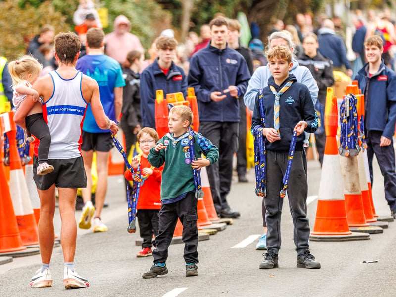 Runners collect their medals at the finish line