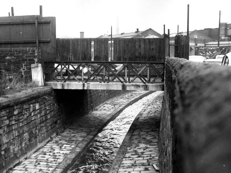 This view from November 1965 shows one of the bridges over Hol Beck alongside Water Lane.