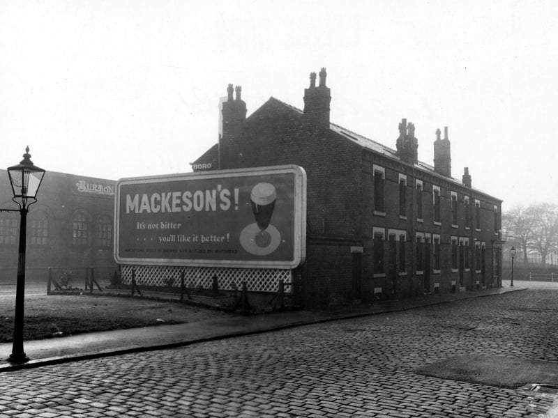 This view from November 1952 looks south west down Compton Place to the junction with Stanley Road, close to where it joins Stoney Rock Lane. The wall and trees in the distance on the right are part of the cemetery. The road between the terrace of houses and factory on the left is the north-east end of Stoney Rock Lane.