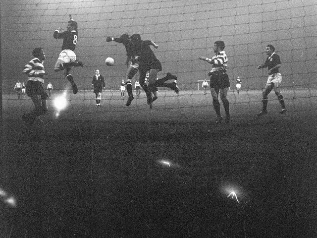 A player clashes with the goalkeeper during a match between Dundee and Sperting Club Lisbon at Dens Park in October 1962.