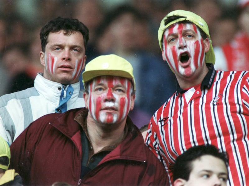 Sheffield United fans with painted faces cheer on the Blades against Manchester United in the FA Cup in 1993