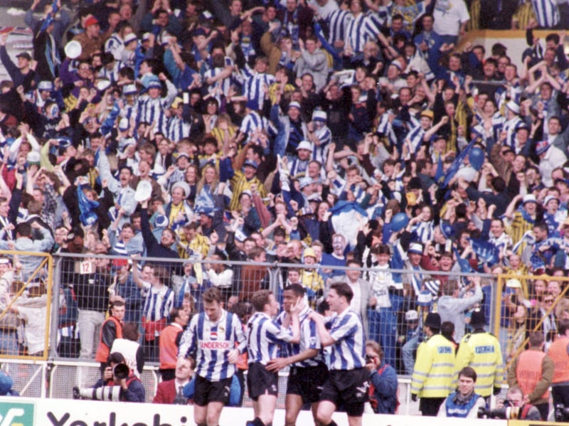 Players and fans celebrate Mark Bright's winning goal for Sheffield Wednesday against Sheffield United in the FA Cup semi-final at Wembley on April 3, 1993