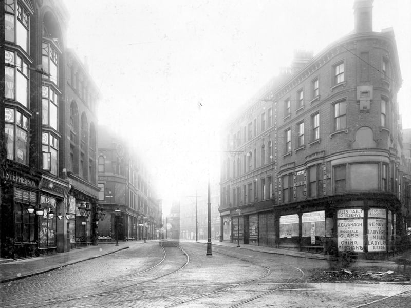 Looking up New Market Street towards Vicar Lane from Duncan Street in . On the left is Isaac Stephenson, butcher, at 24 New Market Street. Above and at 22 is a Royal Waxwork Exhibition with Ellins and Sons, grocers and butchers, at number 20. Next is the junction with Central Road with Garden Bros (Titan House) clothiers beyond that. Pictured in November 1908.
